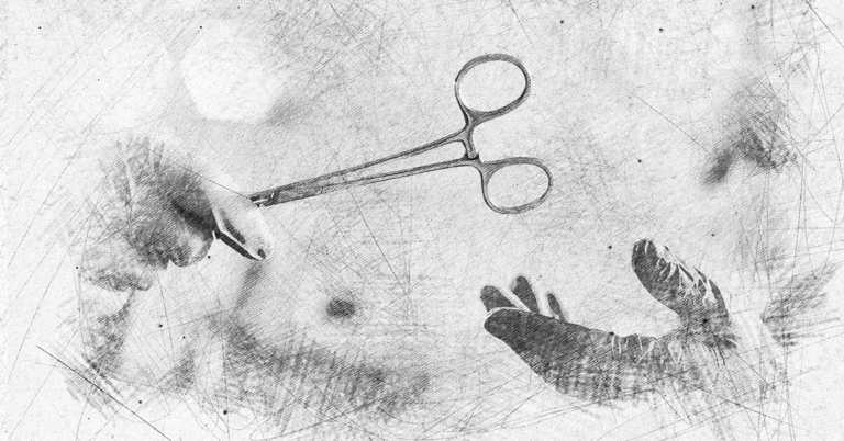 One gloved hand handing a clamp to another glove hand
